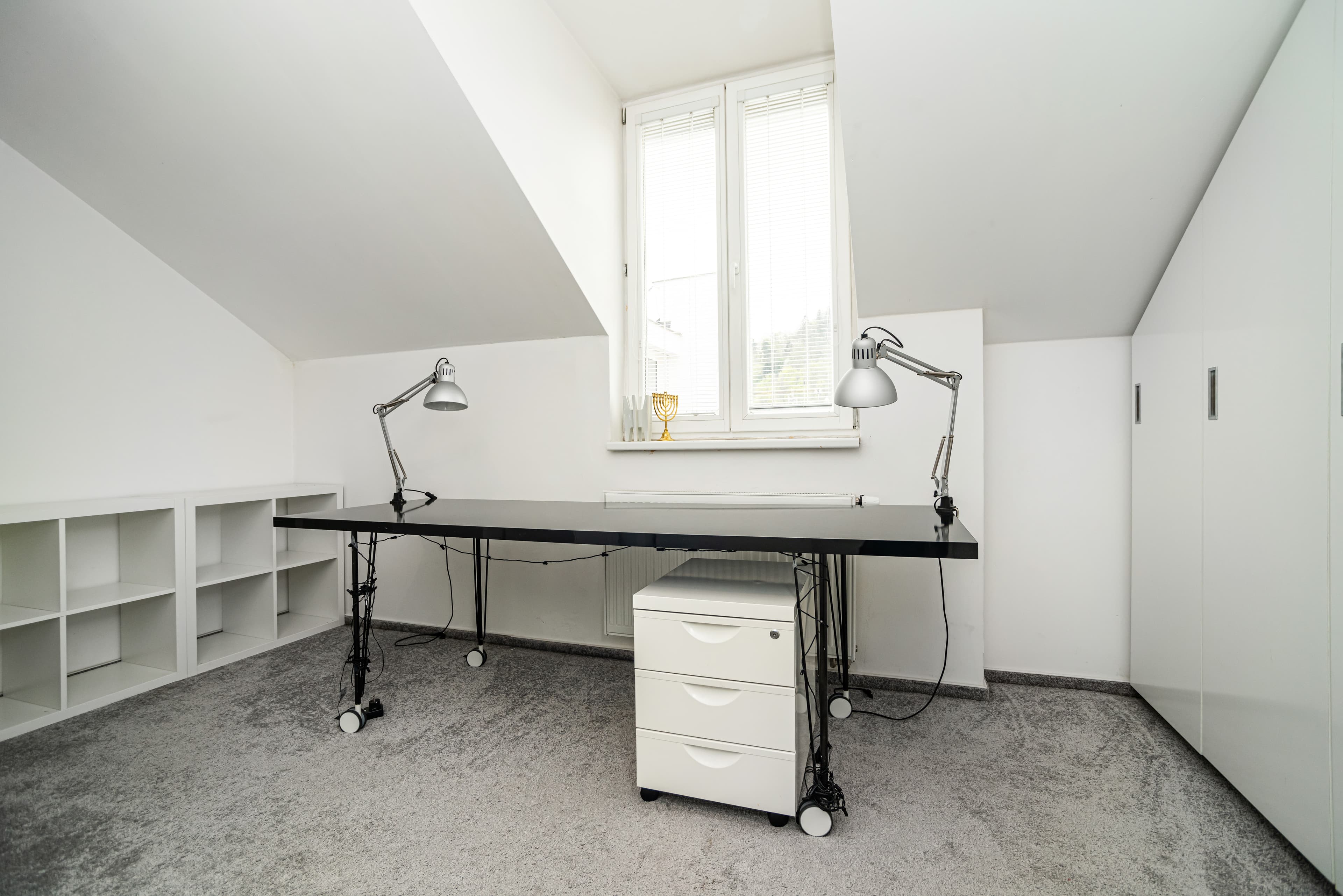Dedicated workspace with external monitor and ergonomic chair in an apartment